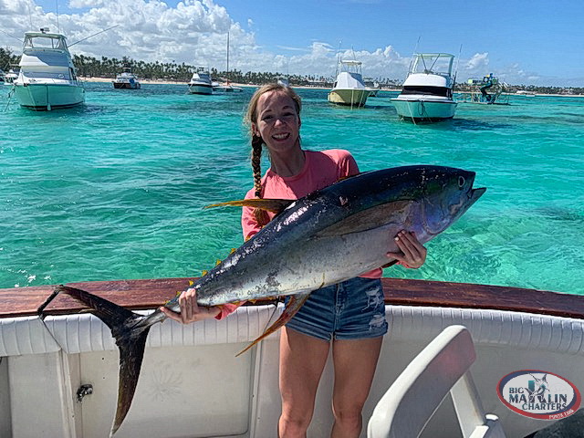 Great and big Yellowfin tuna fishing and girl keep catch in hands Bavaro fishing