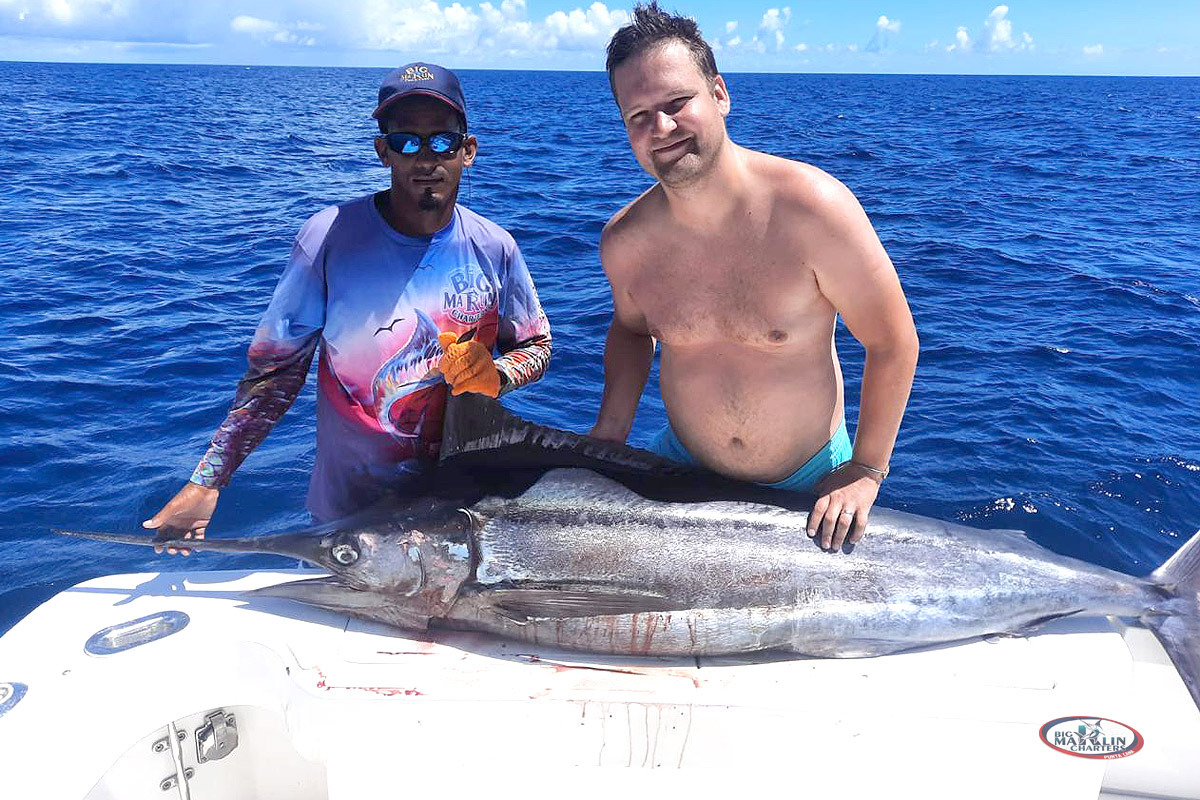 Blue marlin fishing charter boat Blue Sky 36 and clients