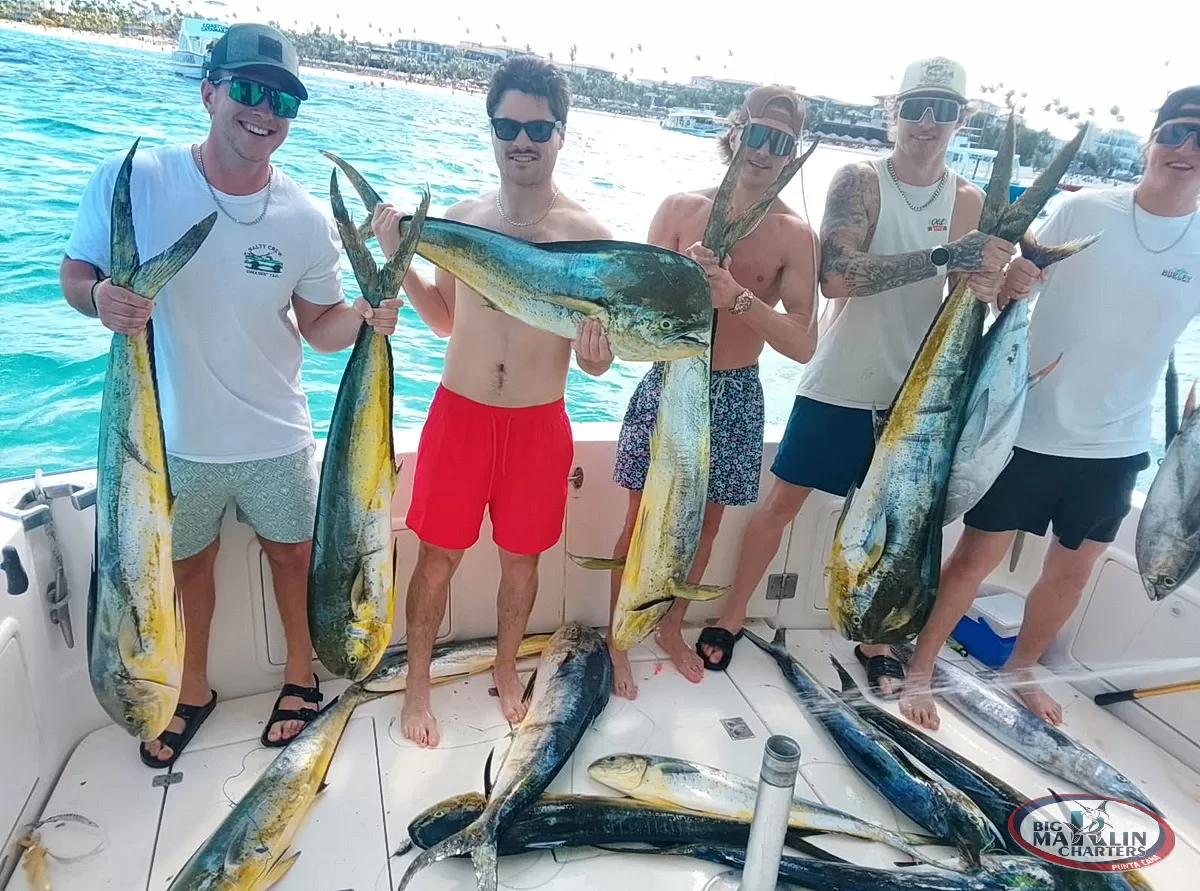 amily enjoying a successful fishing charter experience in Punta Cana with mahi-mahi and wahoo on deck.