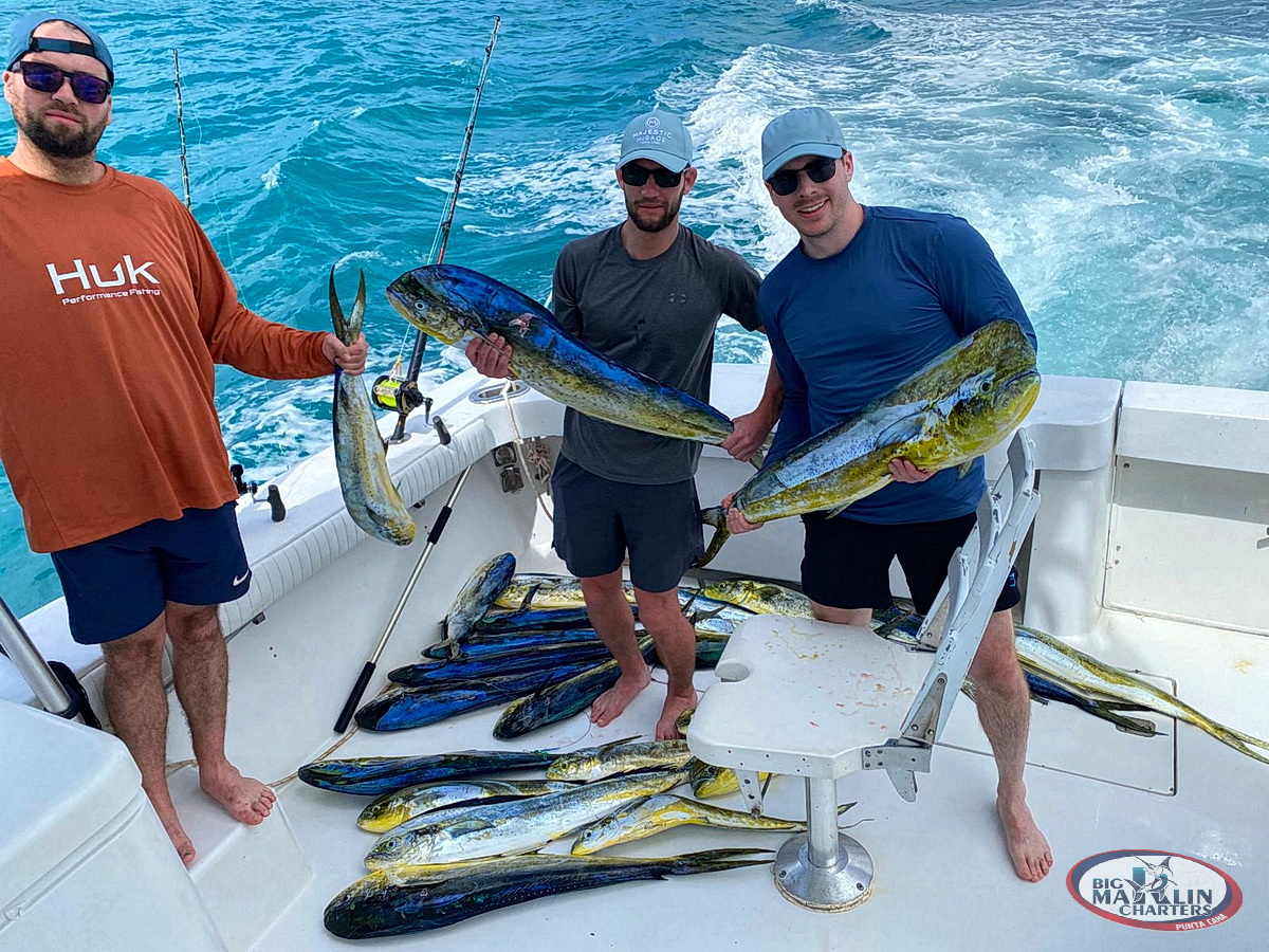 Happy clients celebrating a big mahi-mahi catch during an offshore fishing charter in Punta Cana, Dominican Republic.